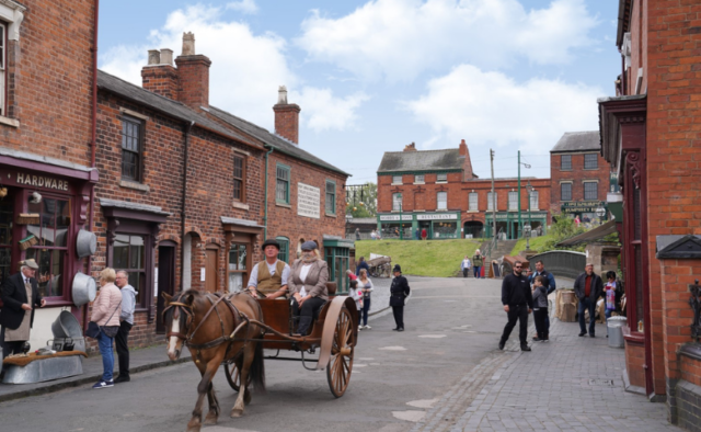 A couple in a pony and trap in the historic street of the Black Country Museum
