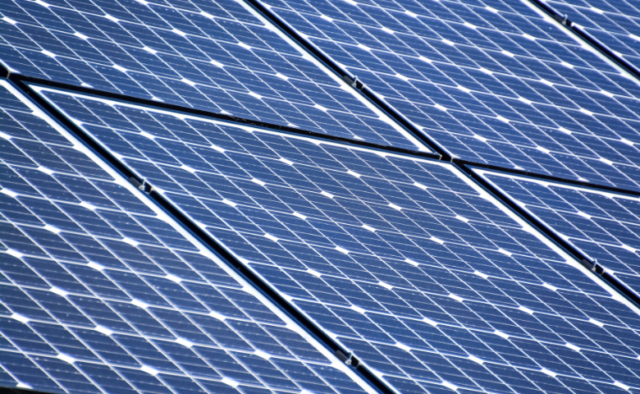 A roof covered in blue solar panels.