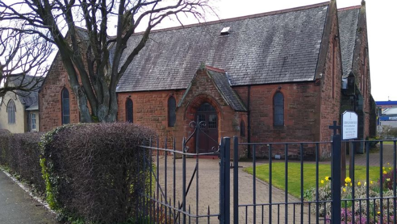Cardonald Parish Church in Glasgow - a small redbrick church behind metal railings