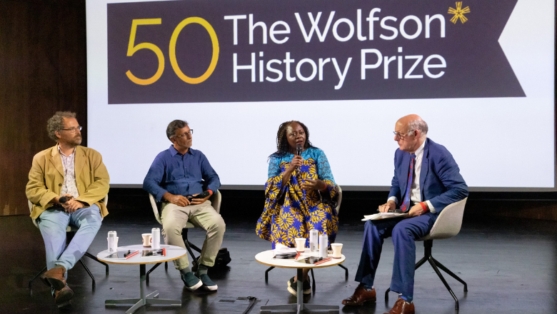 Left to right: Toby Green, Sudhir Hazareesingh, Olivette Otele and David Cannadine sitting on stage in conversation on stage at the V&A at an event for the Wolfson History Prize's 50th anniversary