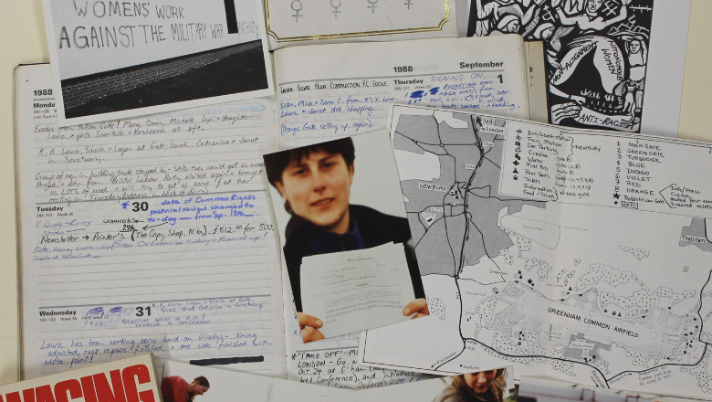 A pile of books, leaflets and archival material scattered on a table.